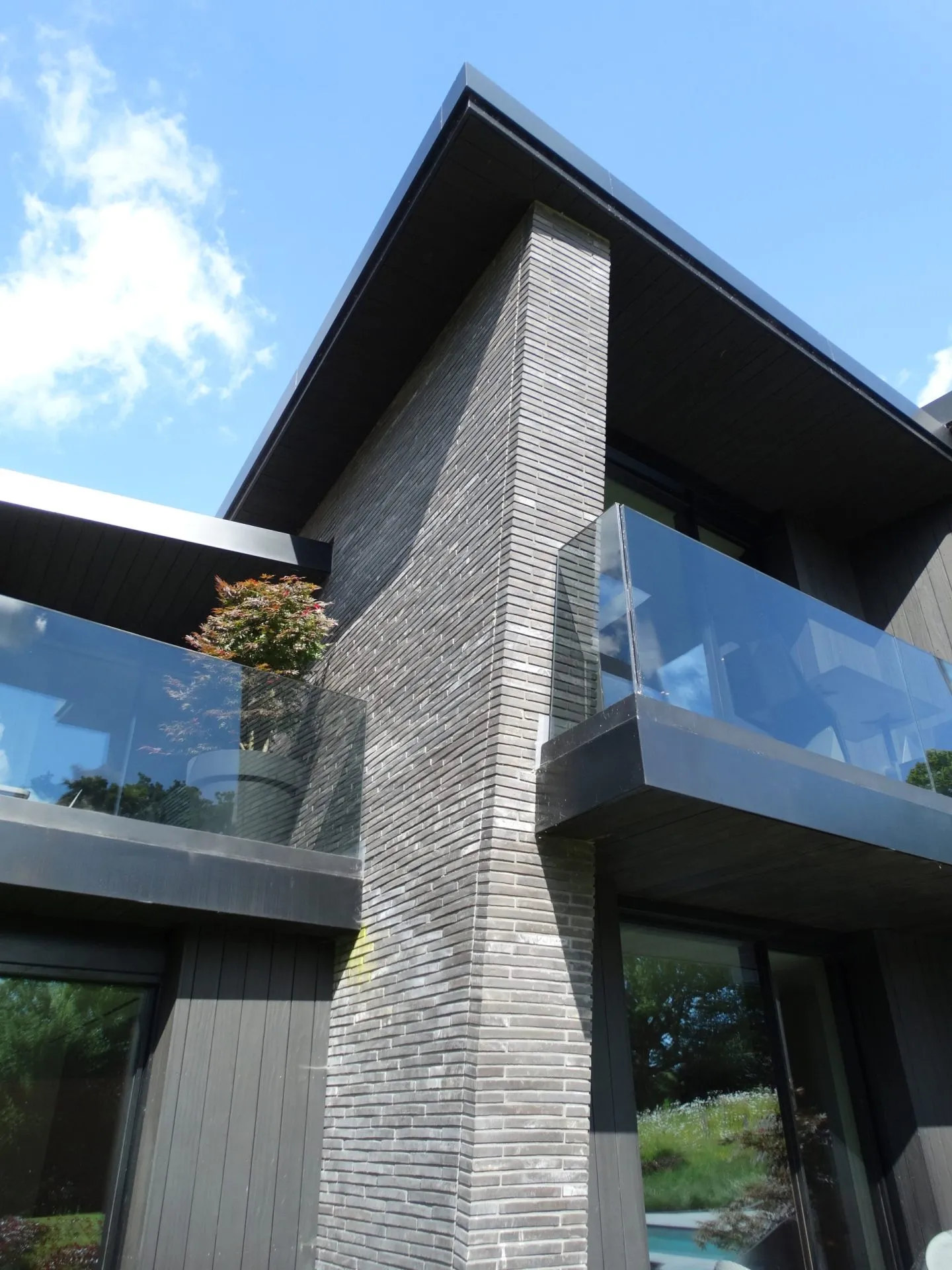 Shards courtyard view, upper roofline cantilevering over the entrance